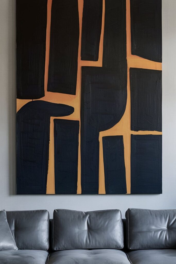 A sophisticated living room with a large, bold abstract painting hanging above a sleek gray couch. The artwork serves as a focal point and sets the color scheme for the room