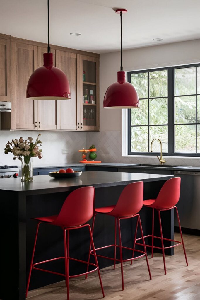 Kitchen with red pendant lights hanging over a black kitchen island and modern red bar stools