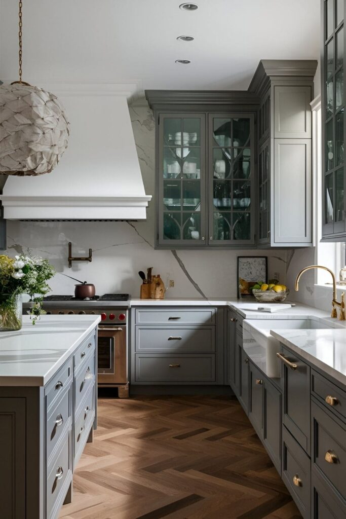 Luxurious kitchen showcasing grey cabinets and elegant white marble countertops with natural veining