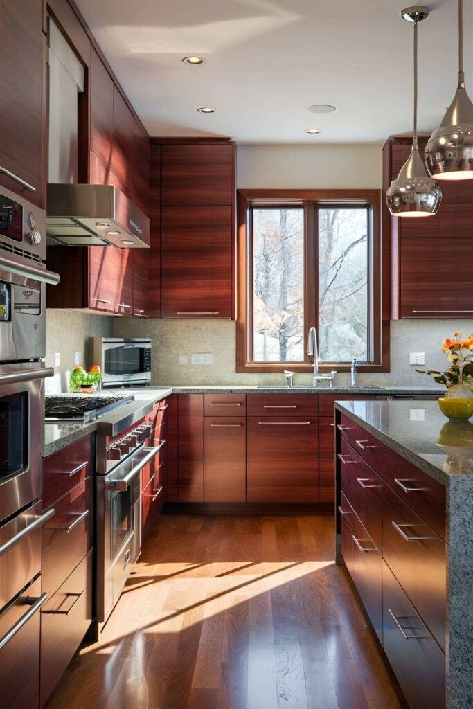 Modern kitchen featuring cherry wood cabinets and sleek stainless steel appliances, creating a warm and cool contrast