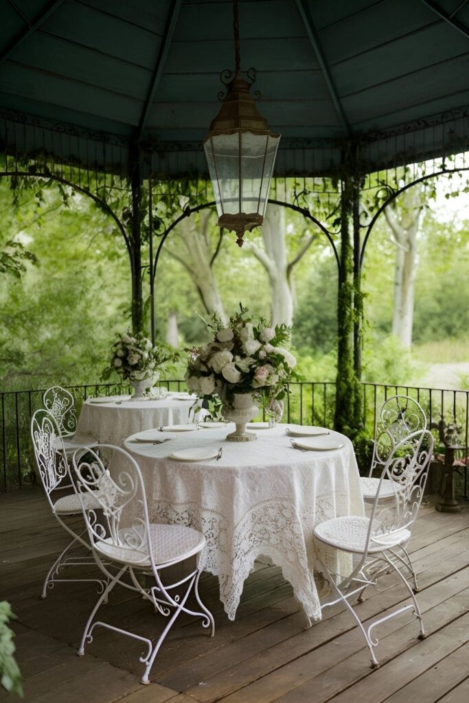 A charming vintage gazebo decorated with wrought iron chairs, lace tablecloths, and antique lanterns, evoking a nostalgic outdoor space