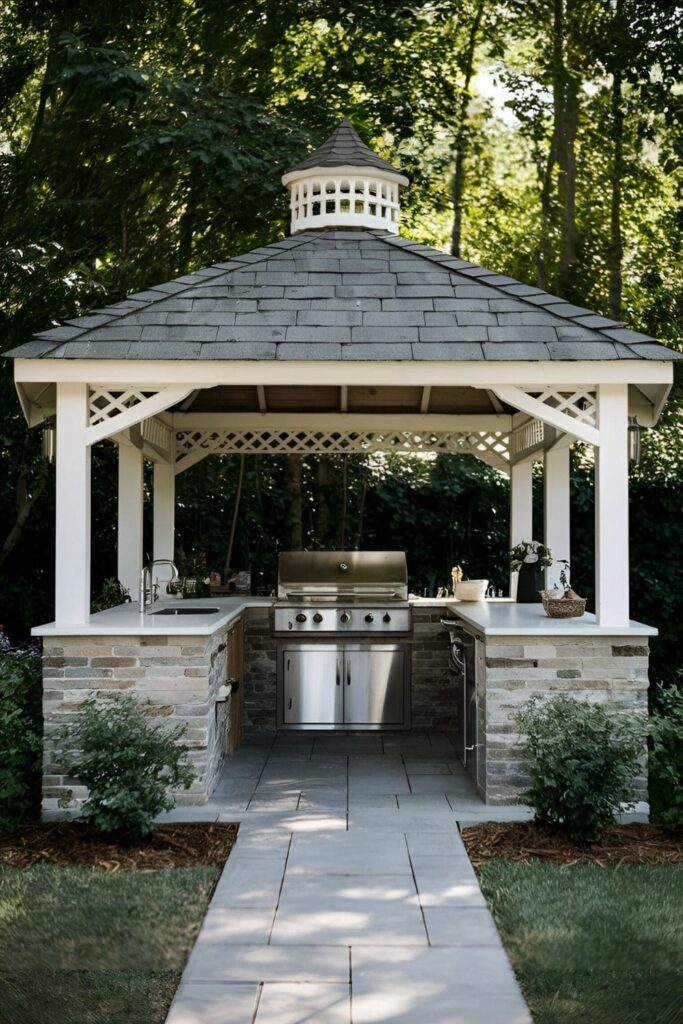 A gazebo with an outdoor kitchen setup, including a grill, countertop, and storage, ideal for summer barbecues and parties