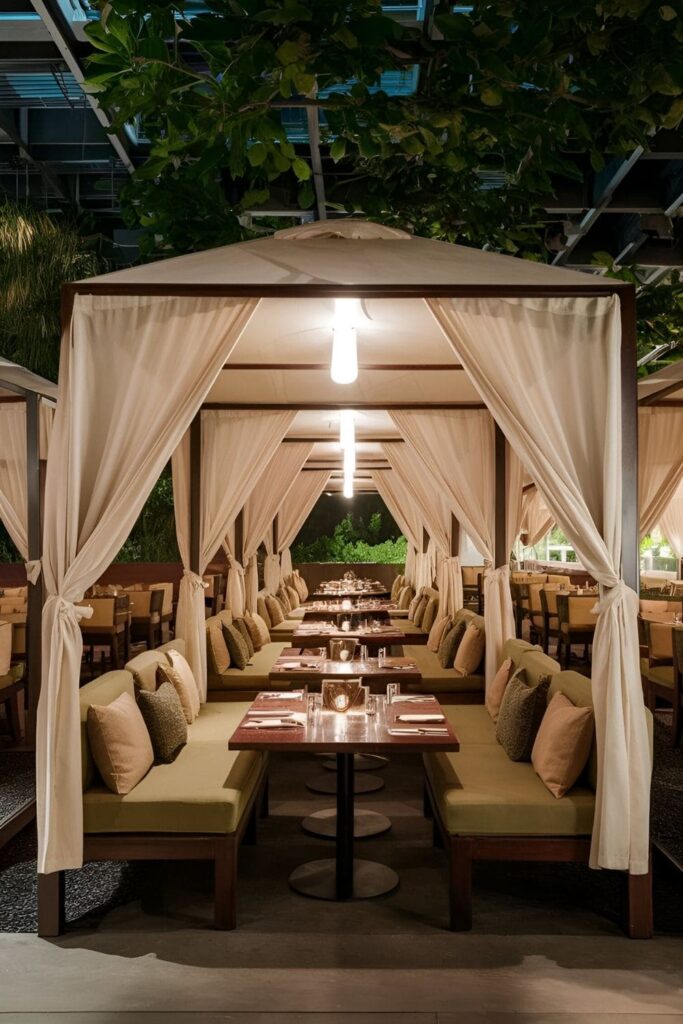 Cabana-style seating areas on patio with canopies or draped fabric