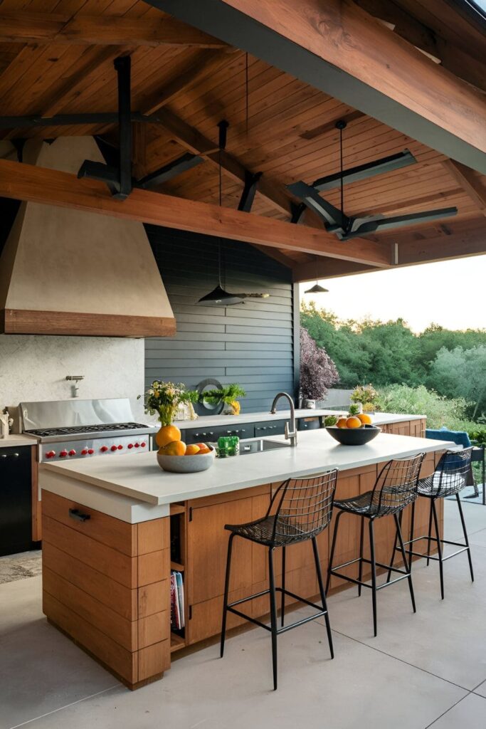 Outdoor kitchen island providing prep space, storage, and seating