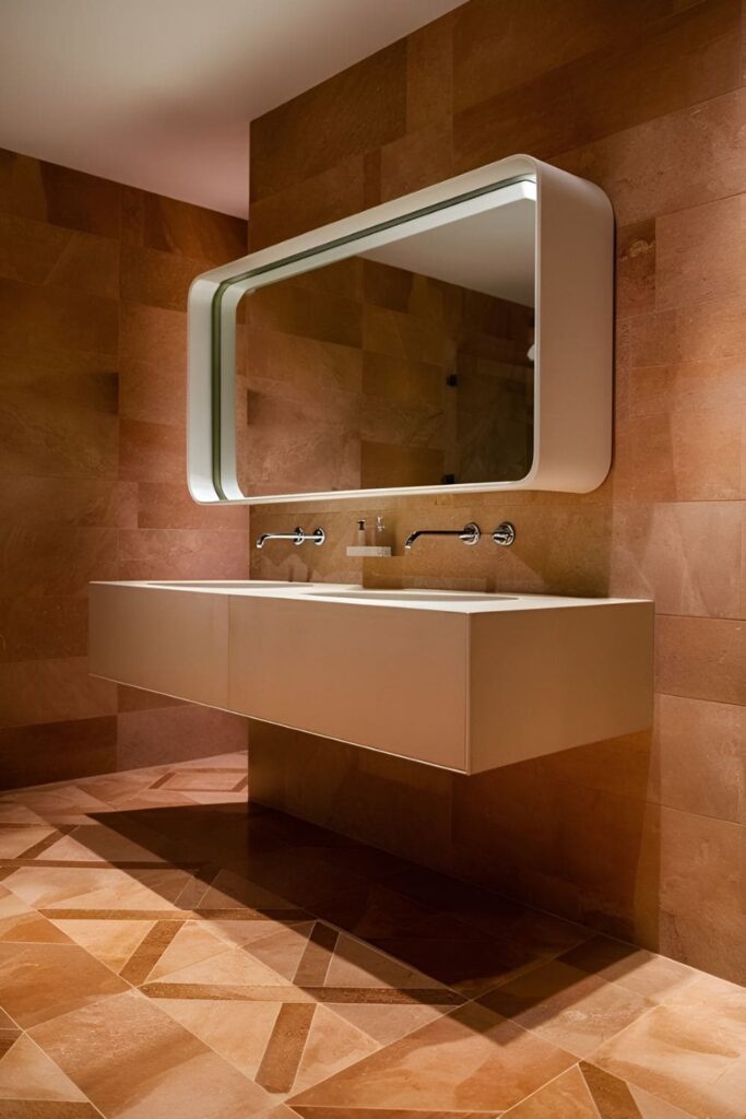 Sleek bathroom featuring a floating vanity mounted on the wall, showcasing attractive flooring underneath