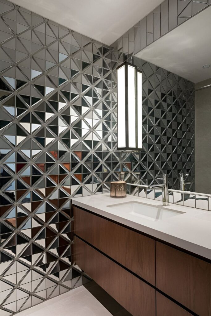 bathroom wall partially covered with peel-and-stick mirror tiles, arranged in a modern pattern to create a reflective and stylish feature