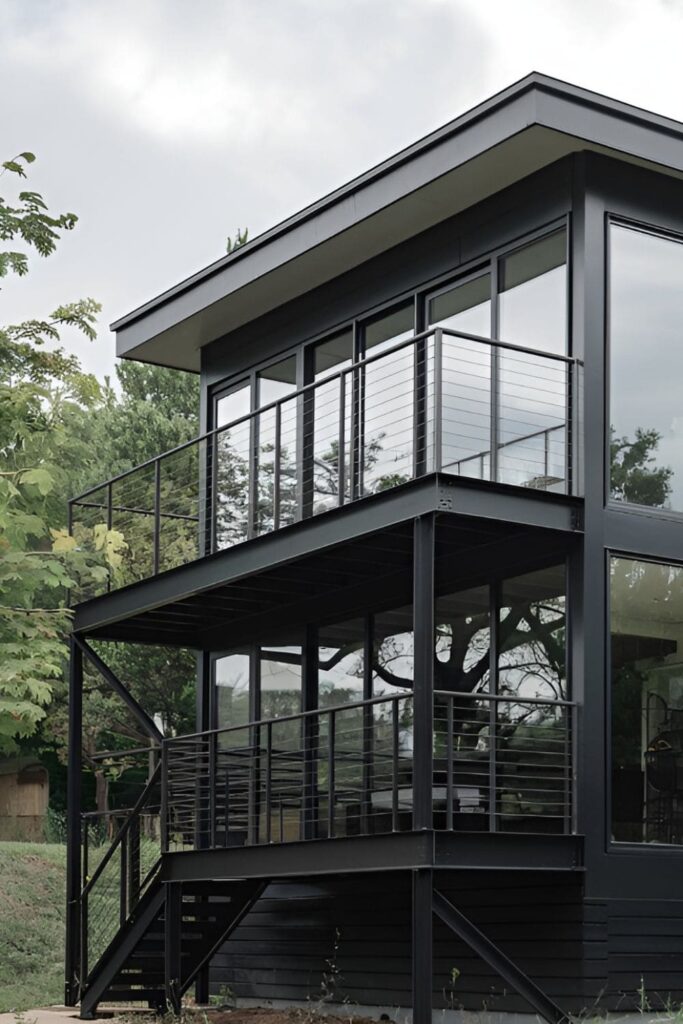 A black house with a metal balcony adding style and outdoor functionality