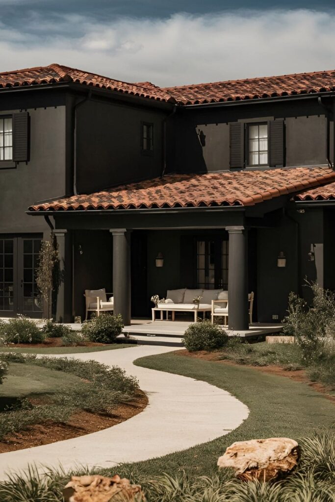 A black house with a terracotta roof blending warm tones and bold black