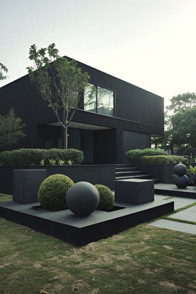 A black house with sculptural landscaping featuring clean lines and topiaries