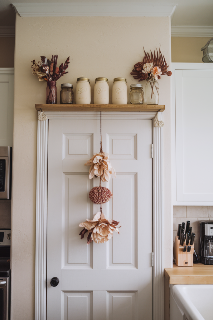 Kitchen doorway topped with a slim wooden shelf displaying jars and seasonal kitchen decor.
