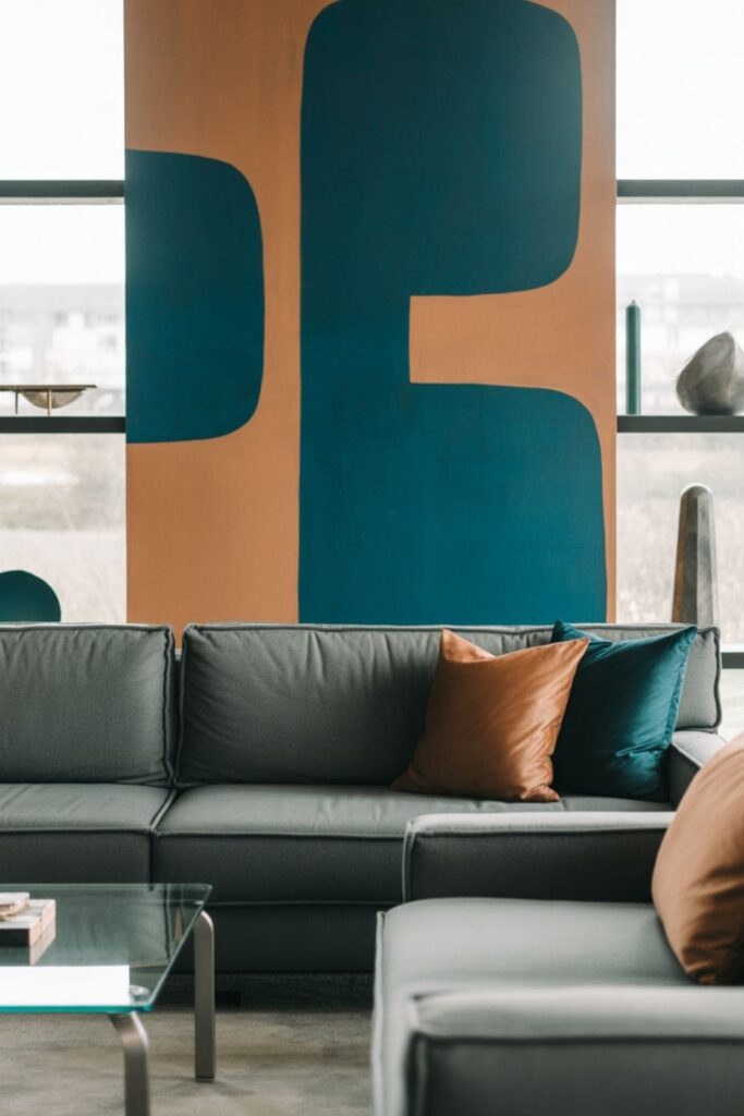 Grey couch styled beneath bold wall art in a modern living room
