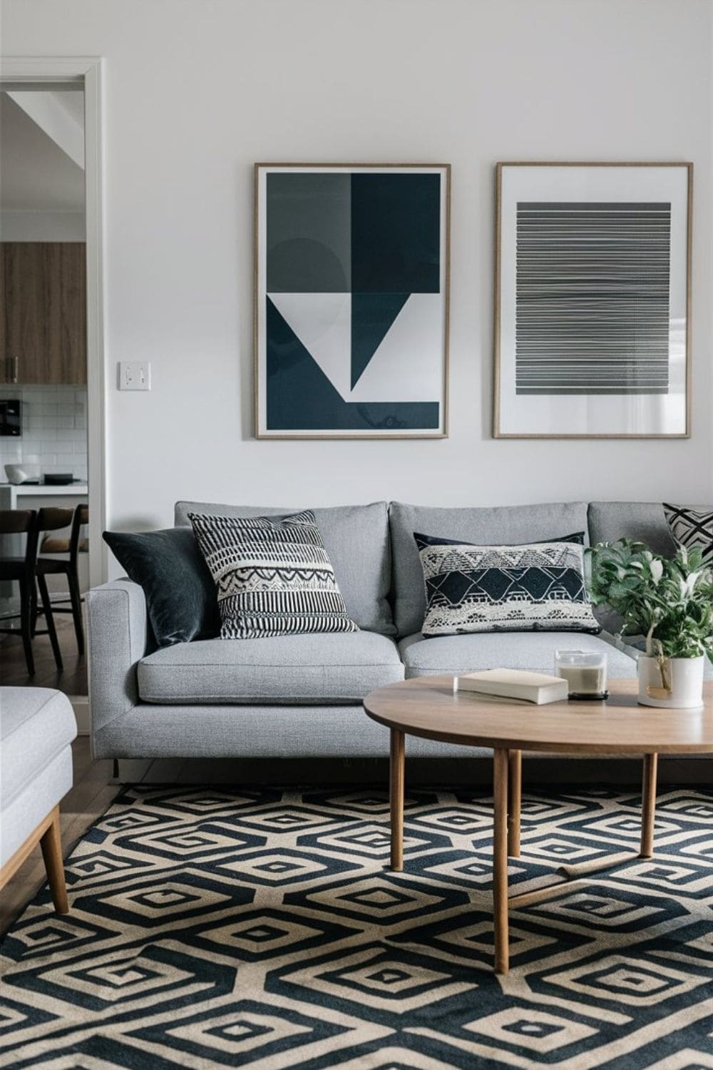 A modern living room decorated with geometric patterns in the rug pillows and wall art