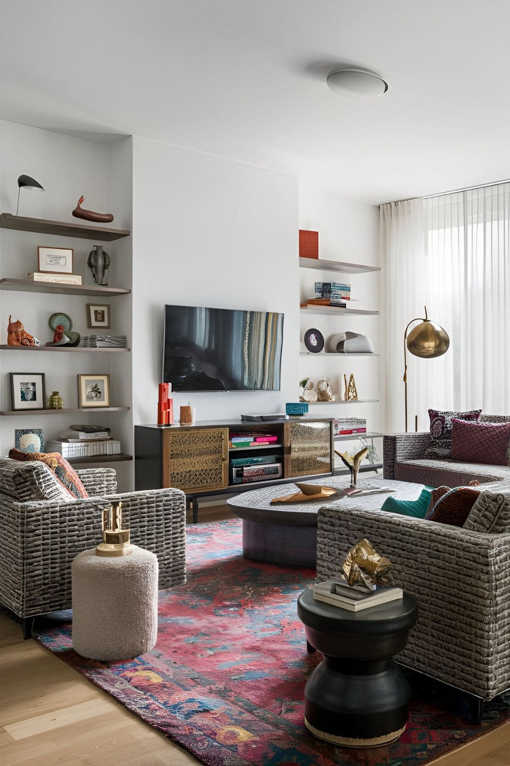 Artistic bohemian I-shaped living room layout featuring patterned and textured furniture a vibrant rug eclectic accessories and a unique media unit