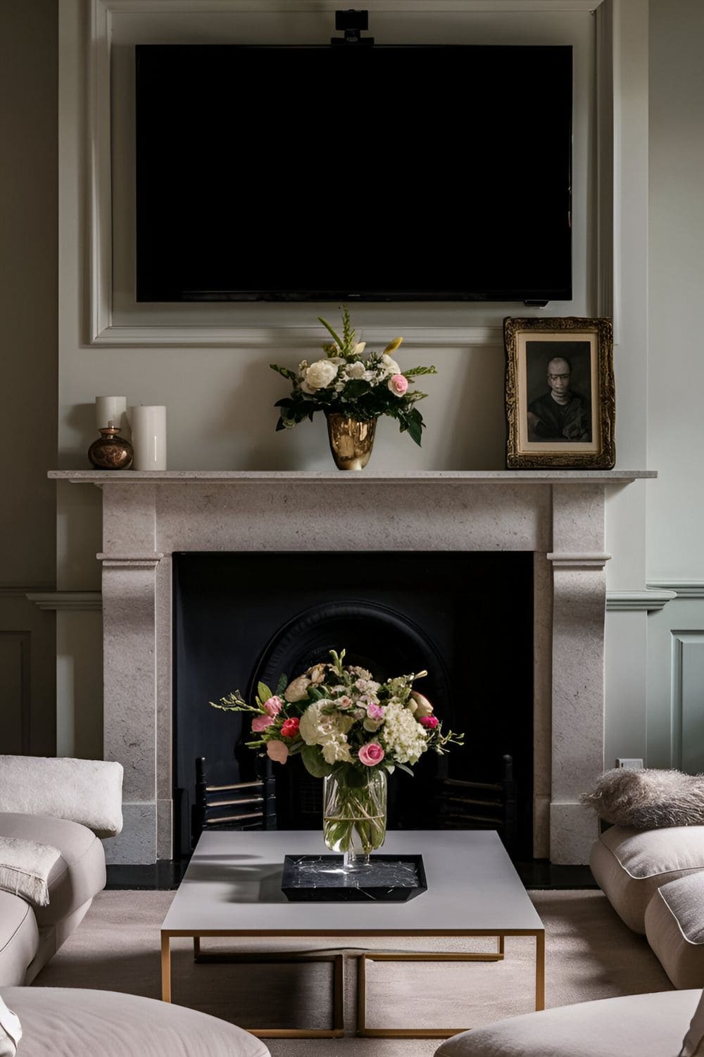 Elegant living room with a TV mounted above a central fireplace lower seating in front