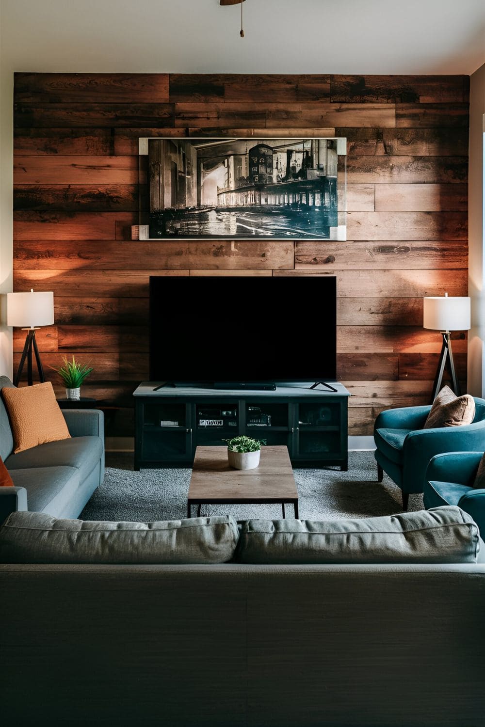 Living room with a TV on a central stand surrounded by a sofa and accent chairs