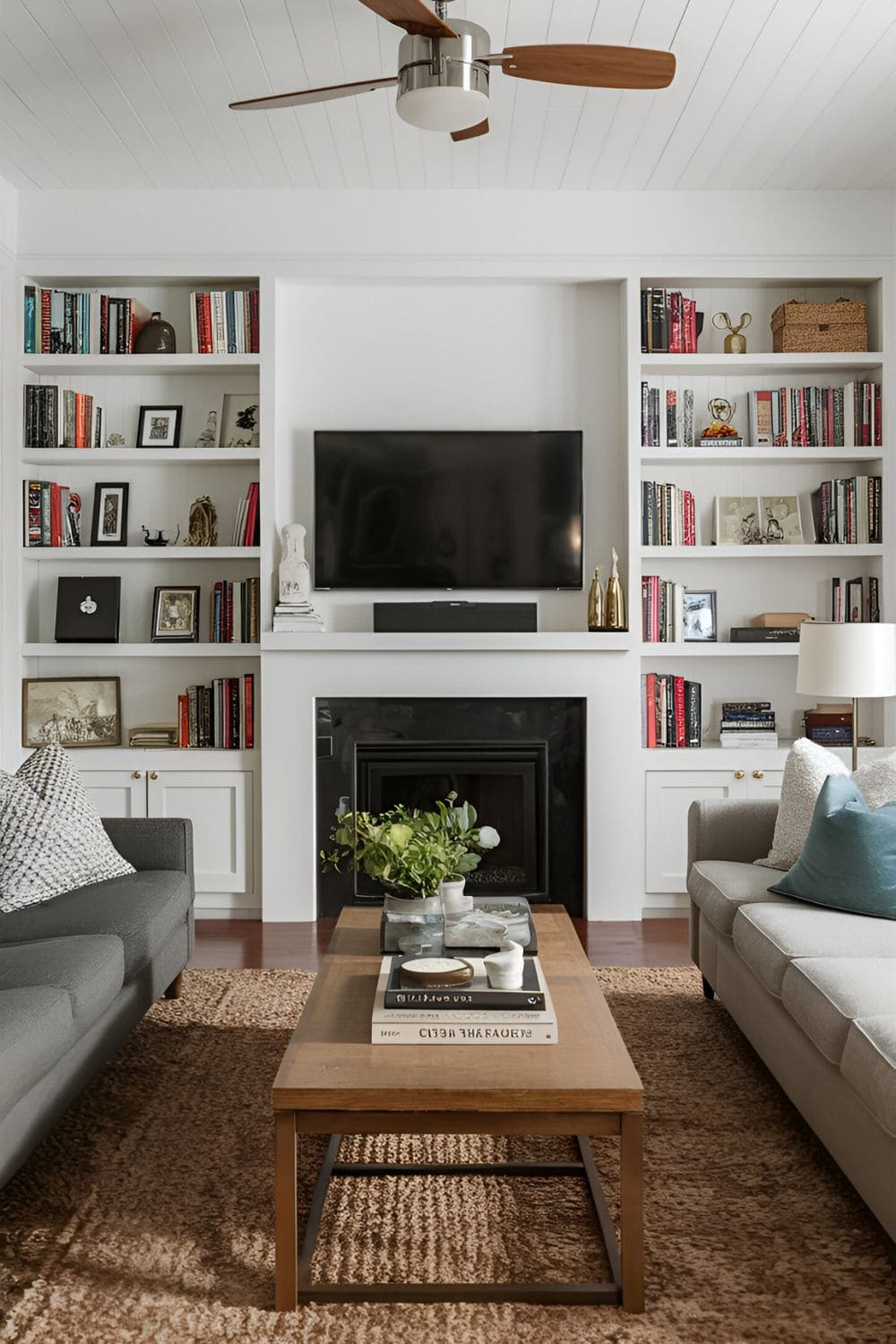 Living room with open shelves framing a TV providing storage and display space