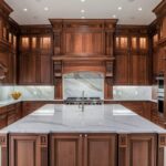 Luxurious and stunning cherry wood cabinets in a kitchen.