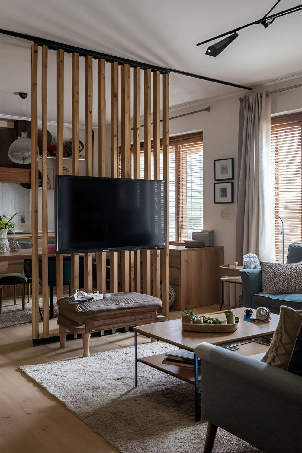 Open-plan living space using a TV as a room divider defining different zones