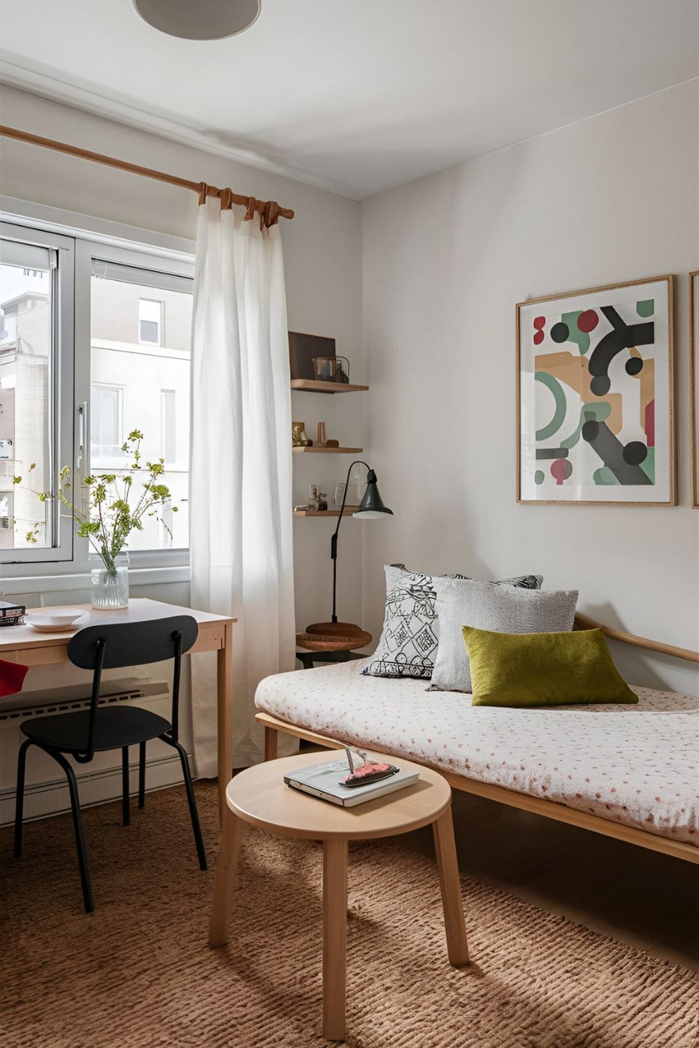 Small living room combining functions with a desk doubling as a dining table and a daybed serving as both seating and a bed making the space versatile