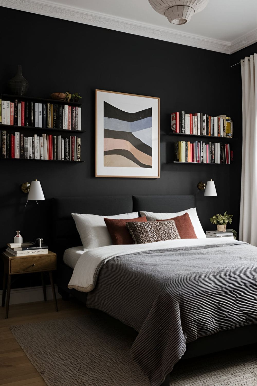 black bedroom with black wall artwork and books