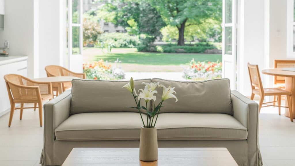 A photograph of a bright, airy open-concept living room designed for effortless flow.